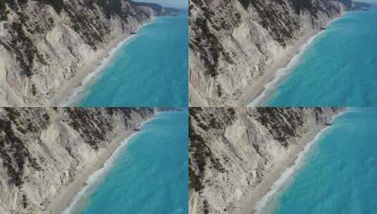 倾斜拍摄在爱琴海的蓝色波浪上，击中莱夫卡达埃格雷姆尼海滩的岸边高清在线视频素材下载