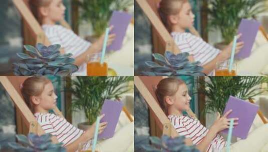 女孩在户外阅读书籍和喝果汁高清在线视频素材下载
