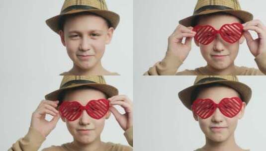 情人节概念男孩戴着有趣的心形眼镜高清在线视频素材下载