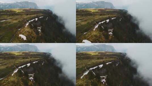 建立镜头显示悬崖侧面覆盖着雾、云和绿色植高清在线视频素材下载