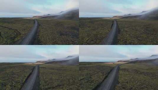 无人机拍摄的冰岛冬季苔藓地里汽车行驶的照高清在线视频素材下载
