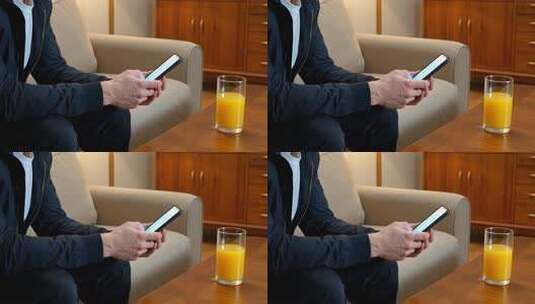 男人居家坐着玩手机高清在线视频素材下载