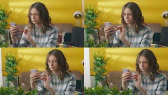 漂亮年轻女子专注于在家浏览手机的中景高清在线视频素材下载