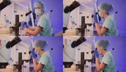 一位女性胚胎学家坐在显微镜旁的实验室里的高清在线视频素材下载