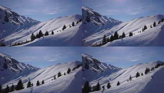 航拍跟随山脊上的滑雪者高清在线视频素材下载