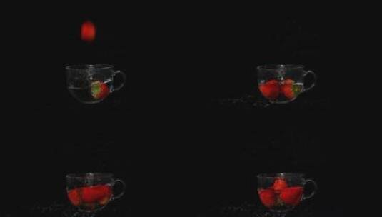 草莓落入玻璃杯中溅起水花的慢镜头高清在线视频素材下载