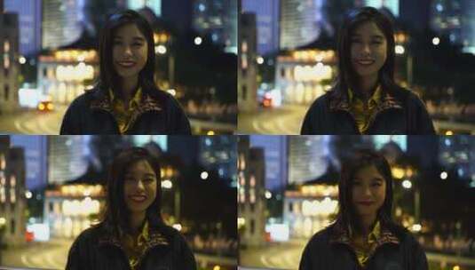 香港街头夜晚面对镜头微笑的女性青年开心笑高清在线视频素材下载