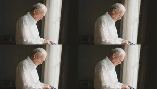 窗边老人整理衣物画面高清在线视频素材下载