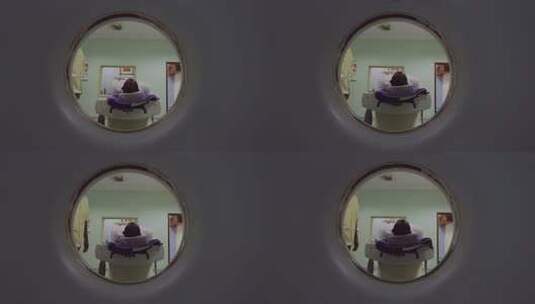 非洲坦桑尼亚透过圆形窗口观察医疗检查场景高清在线视频素材下载