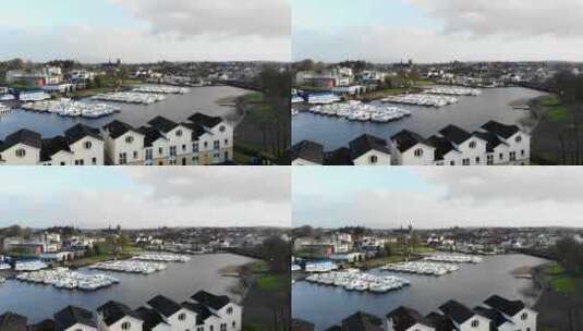 空中——房子飞向码头。船和游艇公园在一个sma的湖边高清在线视频素材下载