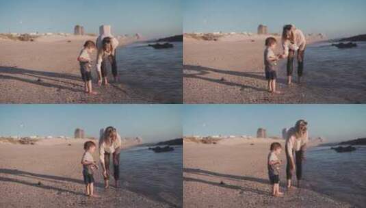 女人和她儿子在海捡石子高清在线视频素材下载