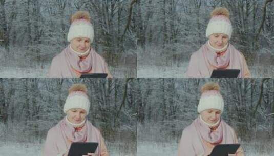 冬天女人带着平板电脑在公园散步高清在线视频素材下载