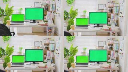 办公室桌子上的绿色屏幕笔记本台式电脑！高清在线视频素材下载