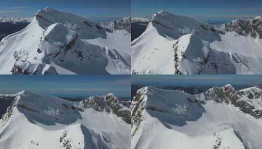 晴朗晴朗的一天，白雪皑皑的山脊的无人机视高清在线视频素材下载