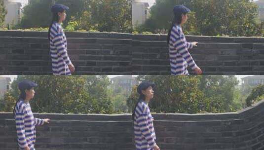 女子行走古城墙眺望远方高清在线视频素材下载