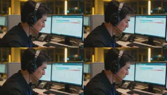 男人办公室戴耳机操作电脑高清在线视频素材下载