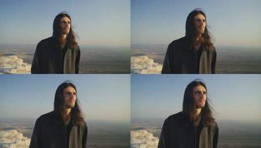 长发男子户外眺望远方高清在线视频素材下载