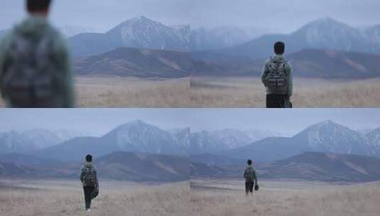 男子背背包眺望远方山脉高清在线视频素材下载