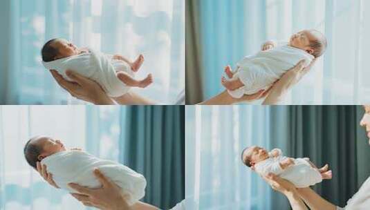 双手托举熟睡的新生儿高清在线视频素材下载