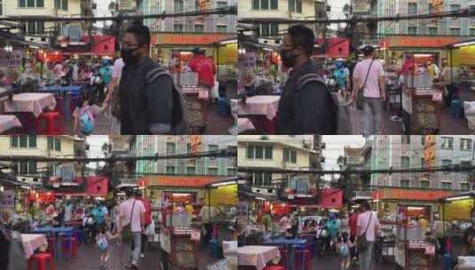 人们走在有小吃摊的街上高清在线视频素材下载