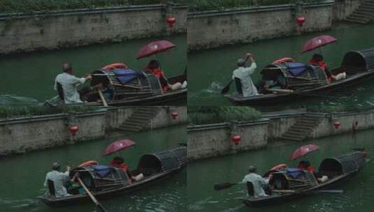 绍兴小雨中中船夫划着乌篷船载客前行高清在线视频素材下载