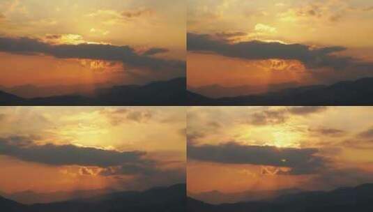 山上日出延时阳光穿过云层丁达尔光耶稣光芒高清在线视频素材下载
