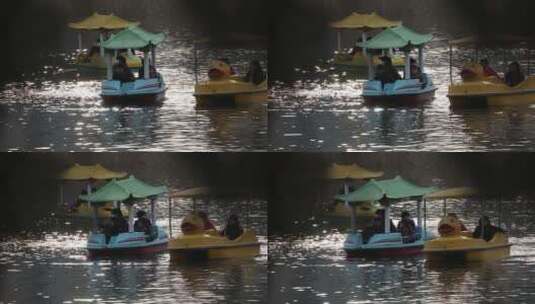 春节期间人们在公园波光粼粼的湖里划船高清在线视频素材下载