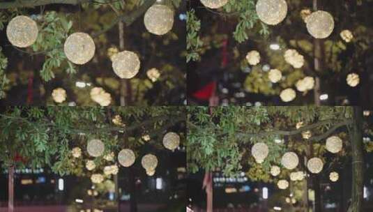 夜晚城市路边树上的灯饰光斑高清在线视频素材下载