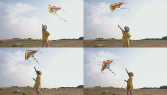 阳光明媚的日子里小女孩在田野里放风筝高清在线视频素材下载