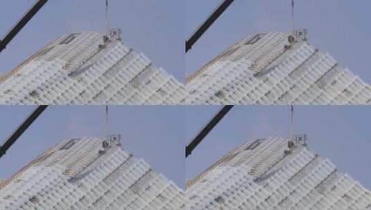 建筑工人城市高空安装作业 玻璃顶蓝天背景高清在线视频素材下载