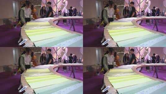 展会内人们查看布料素材高清在线视频素材下载