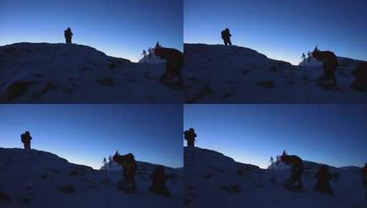 破晓时分的慕士塔格雪山登顶的登山队员高清在线视频素材下载