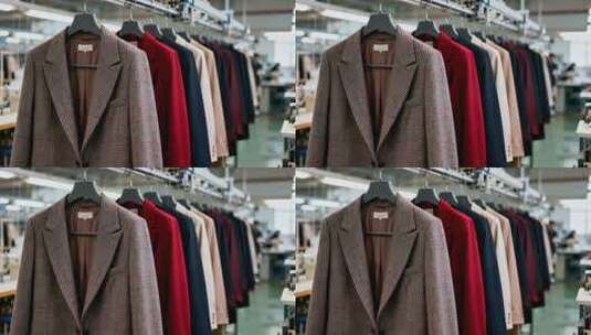 制衣厂内挂放的多件服装高清在线视频素材下载