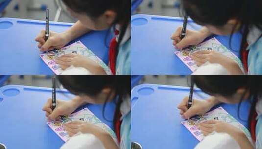 学生在桌前绘画高清在线视频素材下载