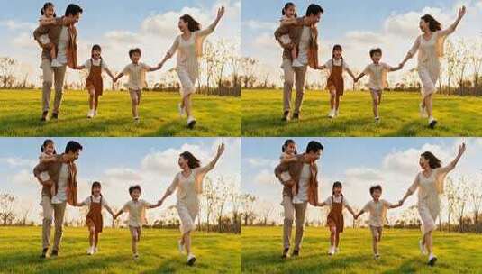 一家四口在草地牵手奔跑高清在线视频素材下载