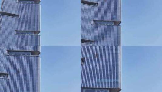 仰视高楼大厦双子塔嵌入式建筑前飞高清在线视频素材下载