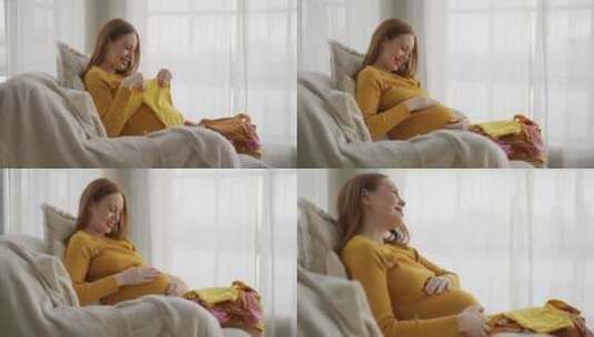 孕妇看婴儿玩具积极的未来母亲享受产妇看婴高清在线视频素材下载