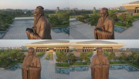 4K航拍夕阳下的孔子雕像高清在线视频素材下载