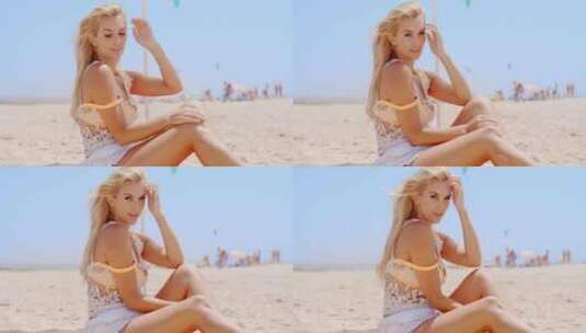 金发美女坐在沙滩上度假高清在线视频素材下载