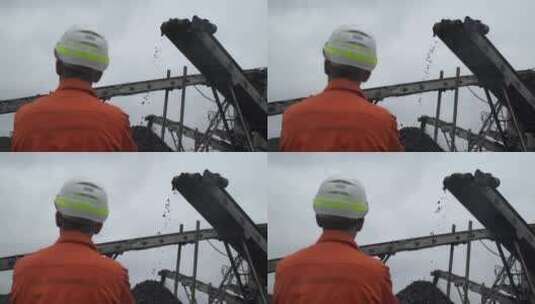 一名煤矿工人观察煤矿开采过程的背面视图高清在线视频素材下载