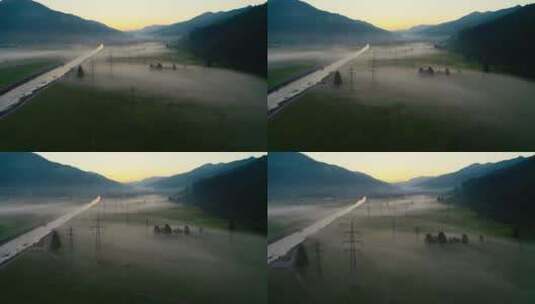 山区河谷草地平原腹地晨雾航拍高清在线视频素材下载