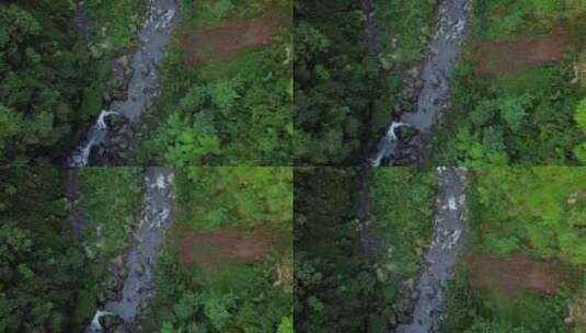 白天在印度尼西亚丛林中漂浮在岩石之间的空中天桥河流溪流-Kedung Ka高清在线视频素材下载