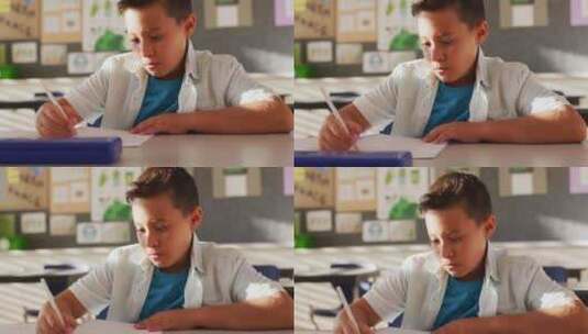 男生坐在课堂上做笔记高清在线视频素材下载