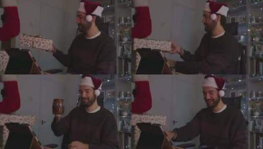 一名男子戴着圣诞帽在视频电话中展示圣诞礼物高清在线视频素材下载