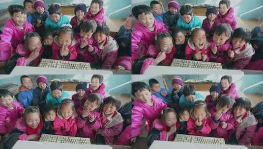 贫困地区的小学生在破旧的教室上课孩子们围绕电脑开心学习高清在线视频素材下载