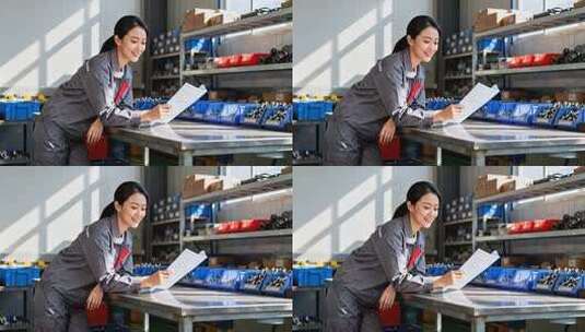 工厂女工人查看文件高清在线视频素材下载