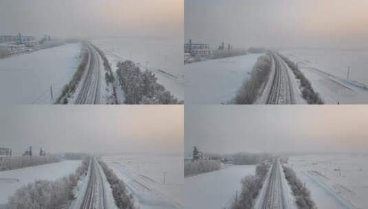 冬季雪天村庄旁的火车道鸟瞰全景高清在线视频素材下载