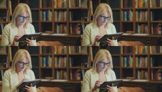 一个女人坐在图书馆看书高清在线视频素材下载