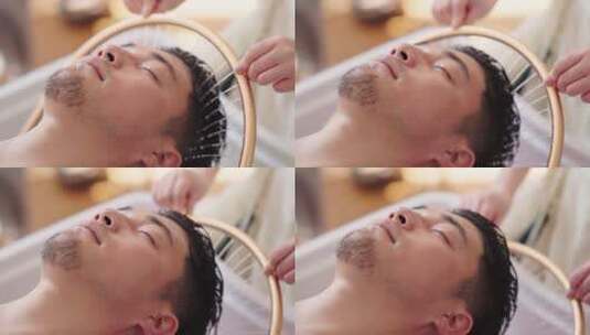 spa会所美女技师为男性客户做头部保健高清在线视频素材下载