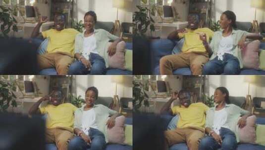 快乐的黑人夫妇在家看电视高清在线视频素材下载